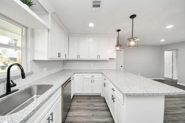 kitchen with visible vents, a sink, dishwasher, and white cabinets