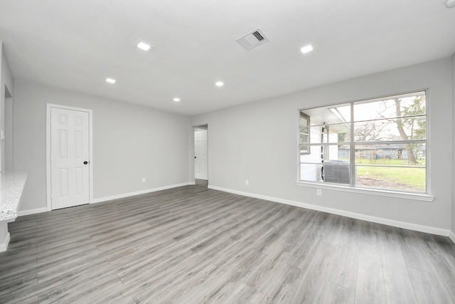 unfurnished living room with recessed lighting, baseboards, visible vents, and wood finished floors
