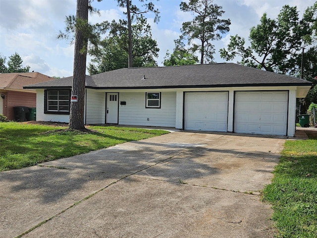 single story home with a shingled roof, an attached garage, concrete driveway, and a front yard