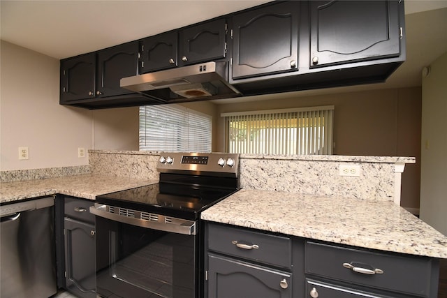 kitchen featuring light countertops, appliances with stainless steel finishes, and under cabinet range hood