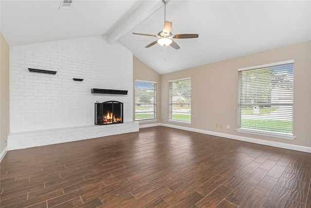 unfurnished living room with a brick fireplace, baseboards, lofted ceiling with beams, a ceiling fan, and dark wood finished floors