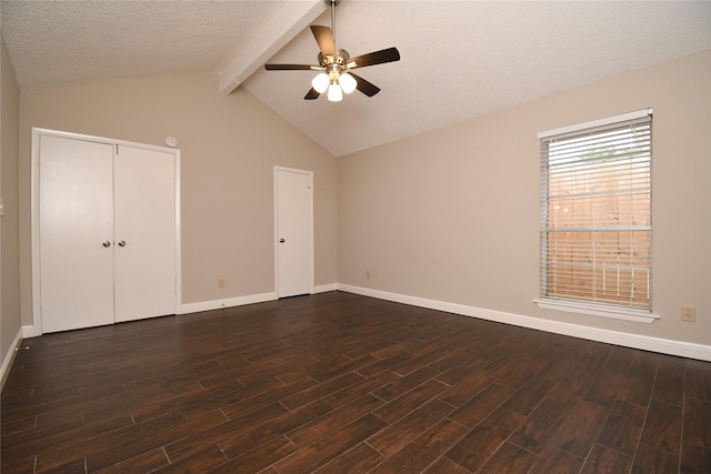 unfurnished bedroom featuring a ceiling fan, a textured ceiling, baseboards, dark wood-style floors, and vaulted ceiling with beams