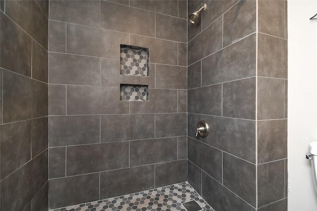 full bath featuring a tile shower