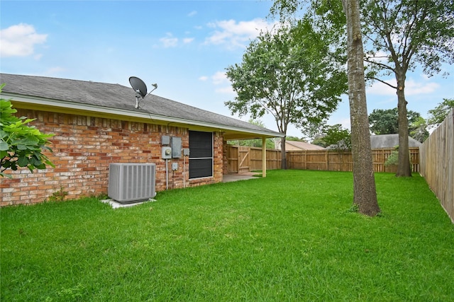 view of yard with central AC and a fenced backyard