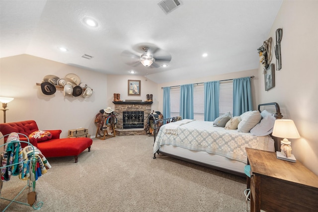 bedroom featuring carpet flooring, a stone fireplace, recessed lighting, vaulted ceiling, and visible vents