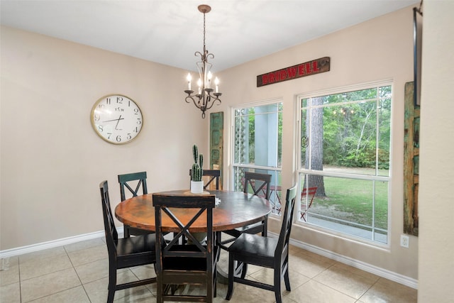 dining area with baseboards, plenty of natural light, and a chandelier