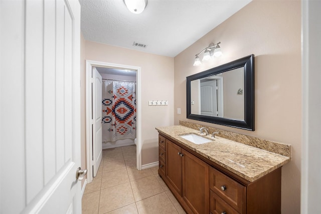 bathroom featuring vanity, tile patterned floors, baseboards, curtained shower, and visible vents