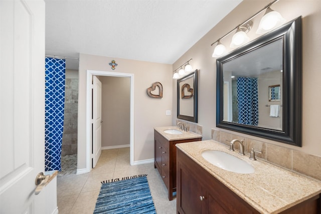 bathroom featuring tiled shower, a sink, and tile patterned flooring
