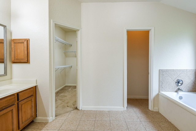 2318 Appian Way, Pearland, TX 77584 - bathroom featuring vanity, a spacious closet, a bath, and tile patterned flooring