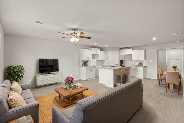9001 Judwin St, Houston, TX 77075 - living room with ceiling fan, recessed lighting, light wood-style flooring, and visible vents