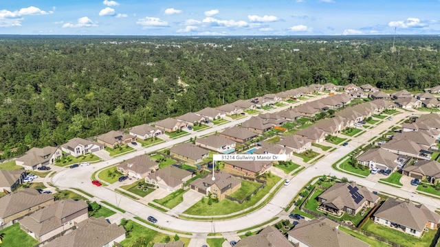 31214 Gullwing Manor Dr, Tomball, TX 77375 - drone / aerial view featuring a forest view and a residential view