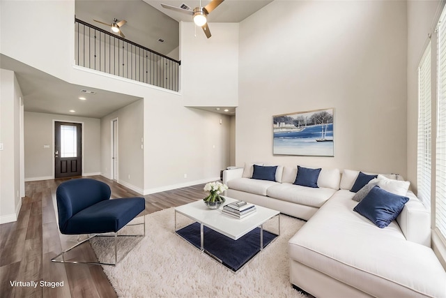 31214 Gullwing Manor Dr, Tomball, TX 77375 - living room with baseboards, a ceiling fan, a high ceiling, and wood finished floors