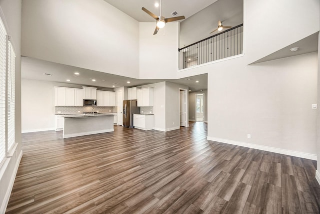 31214 Gullwing Manor Dr, Tomball, TX 77375 - unfurnished living room featuring visible vents, a ceiling fan, dark wood finished floors, and baseboards