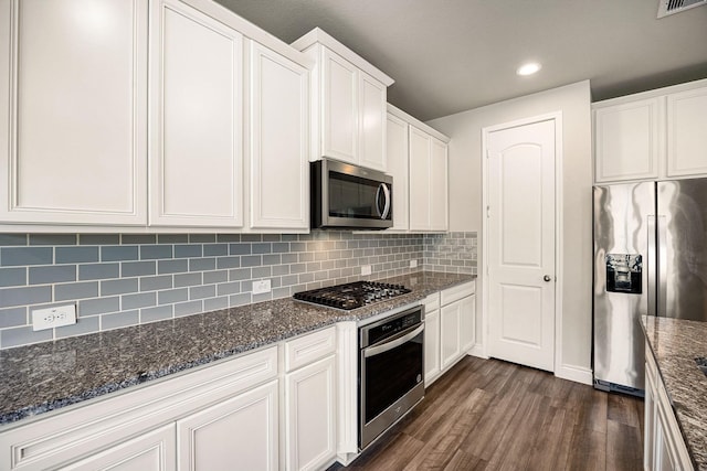 31214 Gullwing Manor Dr, Tomball, TX 77375 - kitchen with recessed lighting, dark wood-style flooring, white cabinets, and stainless steel appliances