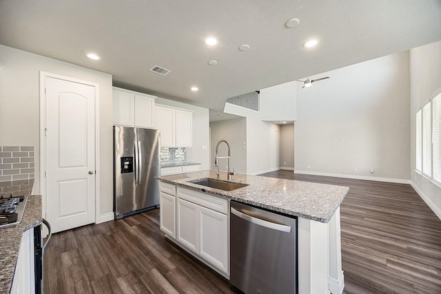 31214 Gullwing Manor Dr, Tomball, TX 77375 - kitchen with a sink, backsplash, stainless steel appliances, and dark wood-type flooring