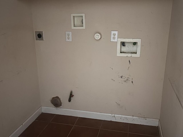 washroom featuring laundry area, electric dryer hookup, hookup for a gas dryer, dark tile patterned flooring, and baseboards