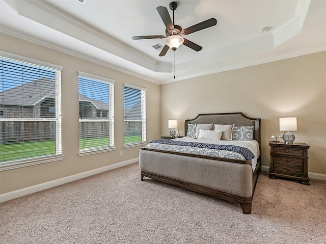 bedroom with crown molding, a raised ceiling, carpet flooring, and visible vents
