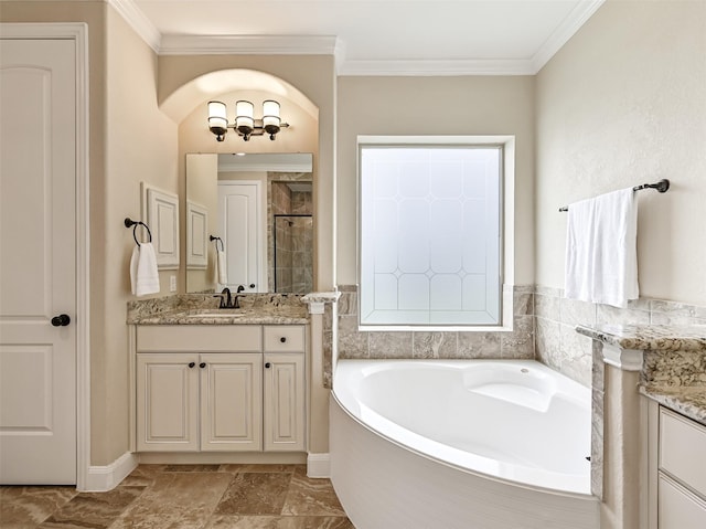 full bath with vanity, a stall shower, crown molding, and a garden tub