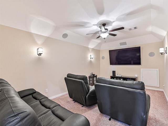 home theater featuring light colored carpet, ceiling fan, visible vents, and baseboards