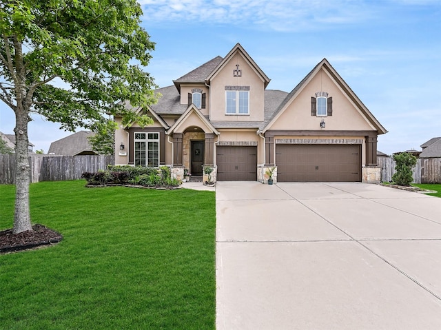 view of front facade featuring fence, stucco siding, concrete driveway, and a front yard