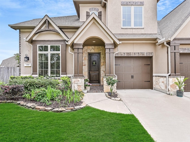 view of front of property featuring stone siding, roof with shingles, stucco siding, concrete driveway, and an attached garage