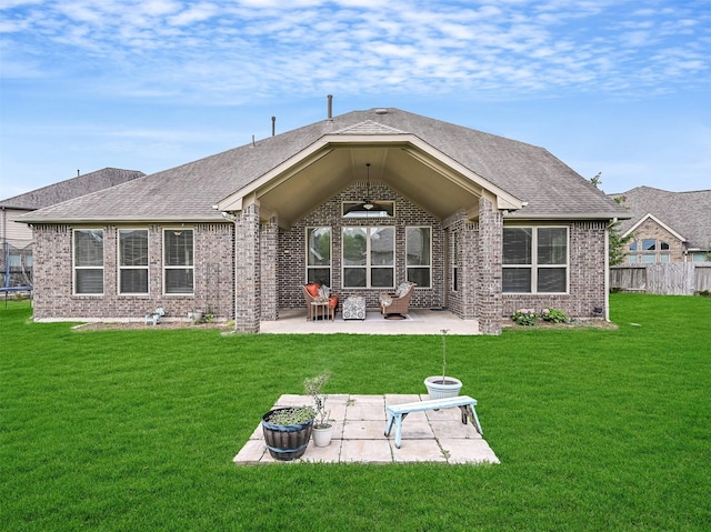 back of house with a yard, brick siding, fence, and a patio