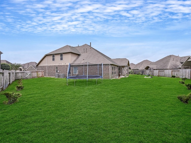 view of yard featuring a fenced backyard and a trampoline