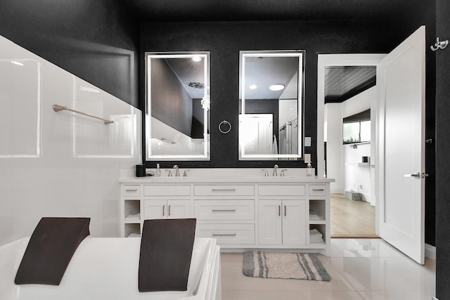 2303 Yupon St, Houston, TX 77006 - bathroom with double vanity, a sink, walk in shower, and tile patterned floors