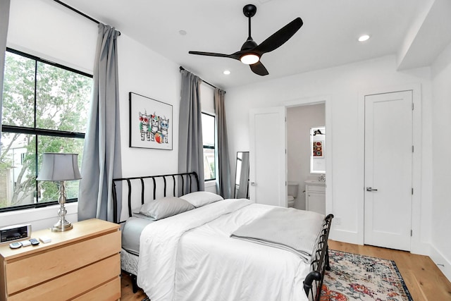 2303 Yupon St, Houston, TX 77006 - bedroom featuring ensuite bath, multiple windows, and light wood-style floors