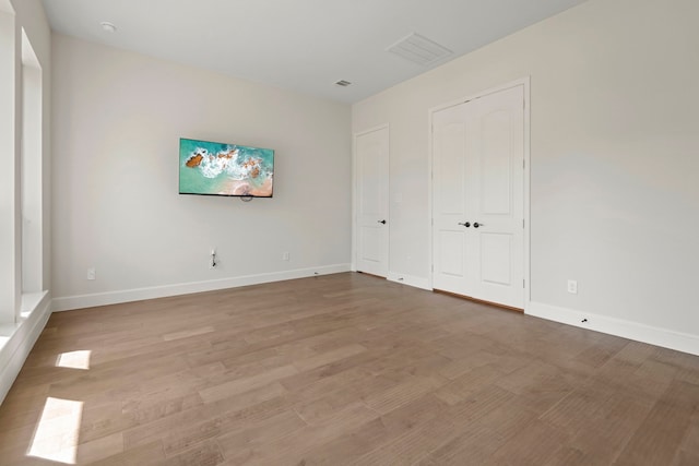 21873 Otter Point Ln, Porter, TX 77365 - unfurnished bedroom featuring baseboards, wood finished floors, and visible vents