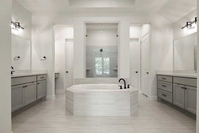 21873 Otter Point Ln, Porter, TX 77365 - bathroom with a tile shower, tile patterned flooring, baseboards, two vanities, and a garden tub