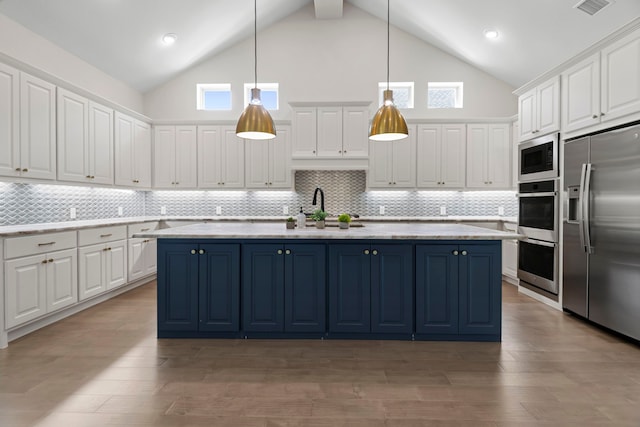 21873 Otter Point Ln, Porter, TX 77365 - kitchen with built in appliances, high vaulted ceiling, and white cabinets