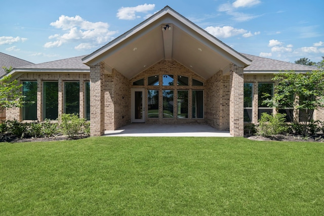 21873 Otter Point Ln, Porter, TX 77365 - back of property featuring a shingled roof, a yard, a patio area, and brick siding