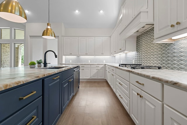 21873 Otter Point Ln, Porter, TX 77365 - kitchen featuring a sink, blue cabinetry, stainless steel appliances, white cabinetry, and decorative backsplash