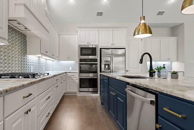 21873 Otter Point Ln, Porter, TX 77365 - kitchen with blue cabinets, visible vents, a sink, white cabinets, and stainless steel appliances