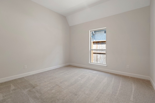 21873 Otter Point Ln, Porter, TX 77365 - spare room featuring baseboards, vaulted ceiling, and light carpet
