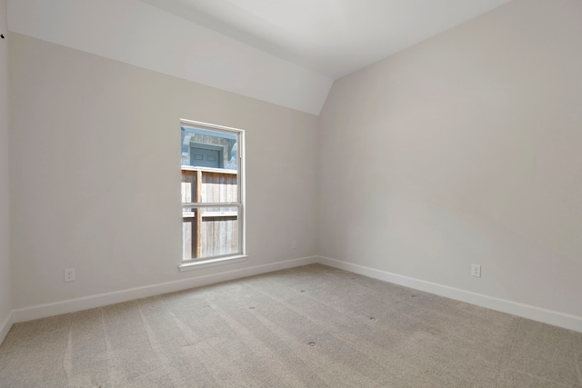 21873 Otter Point Ln, Porter, TX 77365 - unfurnished room with baseboards, vaulted ceiling, and light colored carpet
