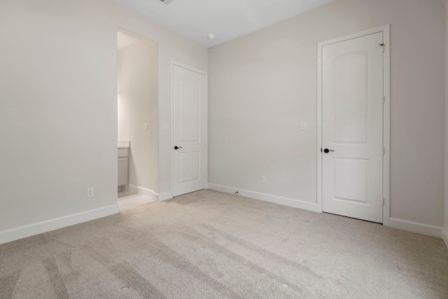 21873 Otter Point Ln, Porter, TX 77365 - unfurnished bedroom with carpet floors, connected bathroom, and baseboards