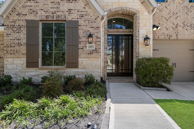 21873 Otter Point Ln, Porter, TX 77365 - property entrance with brick siding, stone siding, and a garage
