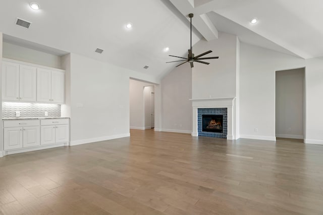 21873 Otter Point Ln, Porter, TX 77365 - unfurnished living room featuring baseboards, beamed ceiling, visible vents, and ceiling fan