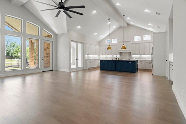 21873 Otter Point Ln, Porter, TX 77365 - unfurnished living room with visible vents, beamed ceiling, high vaulted ceiling, plenty of natural light, and a ceiling fan