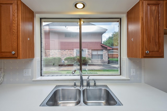 2814 River Birch Dr, Sugar Land, TX 77479 - kitchen with a sink, light countertops, tasteful backsplash, and brown cabinets