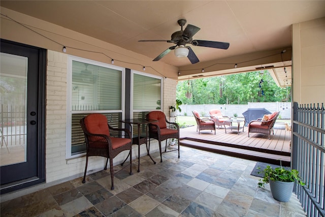 view of patio / terrace featuring fence, ceiling fan, outdoor lounge area, and a deck