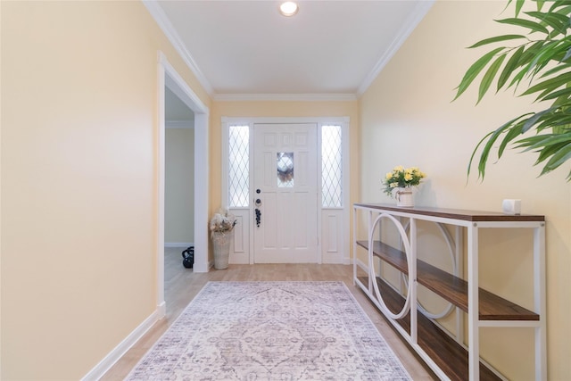 entryway featuring crown molding, baseboards, and wood finished floors
