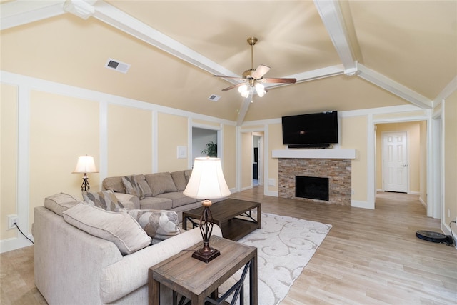 living room featuring visible vents, light wood-style flooring, ceiling fan, and beamed ceiling