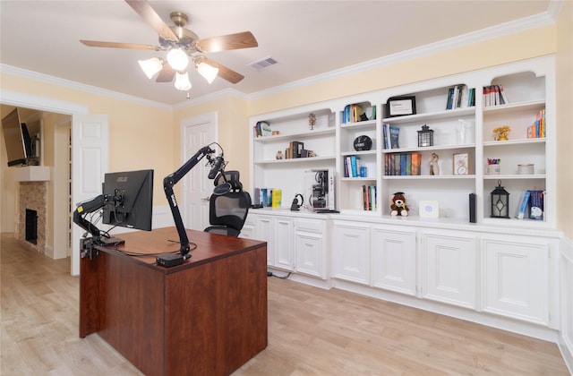 home office featuring visible vents, ornamental molding, ceiling fan, and light wood-type flooring