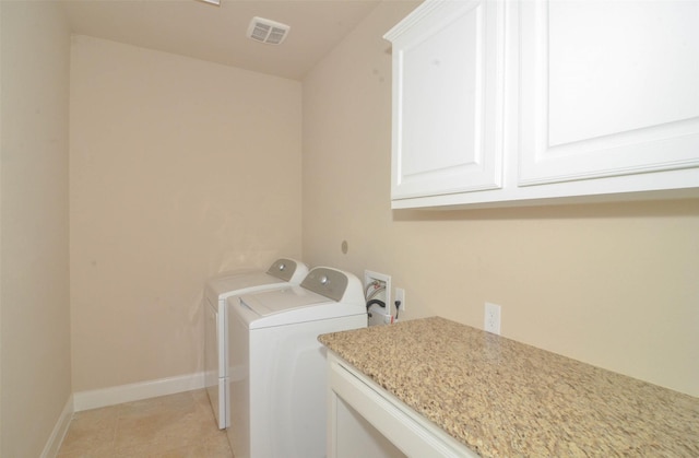 laundry area with cabinet space, independent washer and dryer, baseboards, and visible vents