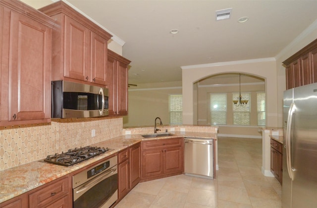 kitchen with visible vents, a peninsula, a sink, backsplash, and stainless steel appliances
