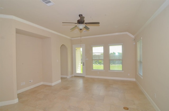 spare room featuring arched walkways, a ceiling fan, baseboards, visible vents, and ornamental molding