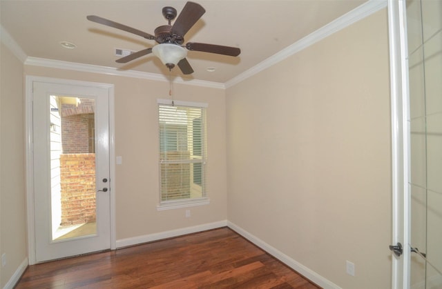 empty room with a ceiling fan, baseboards, wood finished floors, visible vents, and ornamental molding